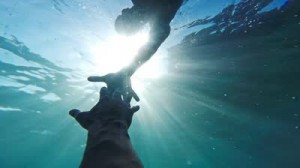 stock-footage-savior-rescuer-salvation-hand-man-drowning-saved-by-lifeguard-underwater-sun-shining-rescue-new