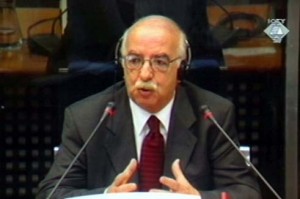 The first witness at the Slobodan Milosevic trial, Mehmet Bakali, continues his testimony before the U.N. court at The Hague, Tuesday Feb.19, 2002 in this image made from television. Bakali, head of the Communist Party in Kosovo during the last years under Josip Broz Tito, told the court on Monday that the Yugoslav leadership under Milosevic had a "scorched earth policy" to wipe out 700 Muslim settlements in Kosovo. (AP PHOTO/ICTY via APTN)